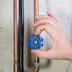 hand turning blue valve off
