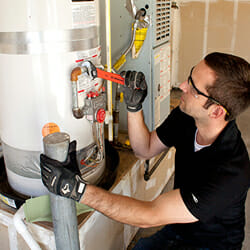 man fixing a water heater