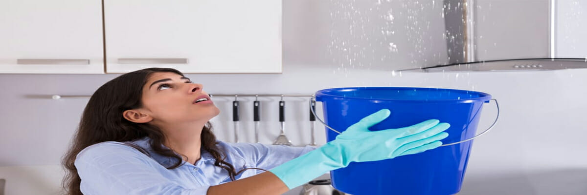 woman holding bucket while dripping water