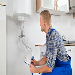 A man checks the electric heater