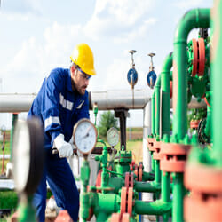 a man checking the temperature and pressure relief valve