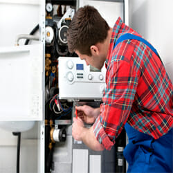 a plumber installing a hot water system