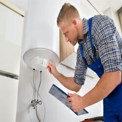 a man adjusting the timer of an off-peak hot water heater