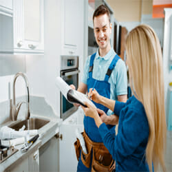 a plumbing contractor talks to the homeowner