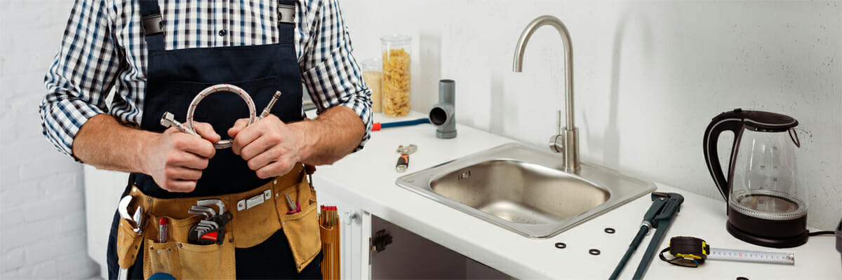 a man holding pipe tools