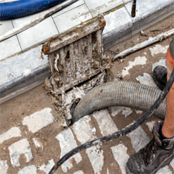 a plumber draining the blockages