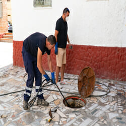 plumbers unblocking the drain