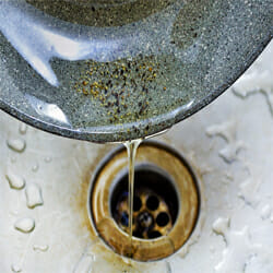 used cooking oil pours in the drain